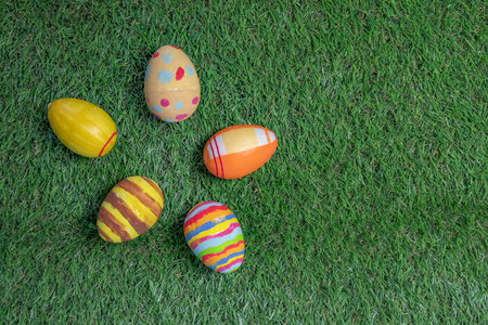 Easter eggs colored on grass top view or flat