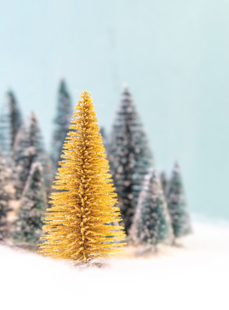 Green Christmas trees forest in front and selective focused a gold colored Christmas tree.の写真素材