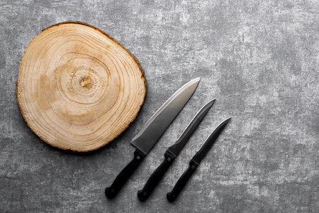 Round wood cutting plate and 3 types of cutting knifes.の写真素材