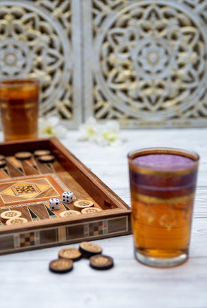 Oldest known board games Backgammon with cups of tee.