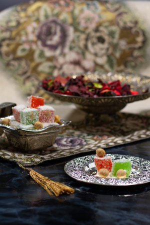 Lokum,Turkish delight a Turkish soft sweet with silver Turkish coffee. Cups. on dark background .の写真素材