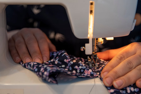 A woman sewing and repairing clothes with a sewing machine at home