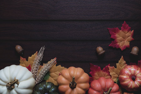 Autumn pumpkin and fall colored leaves.