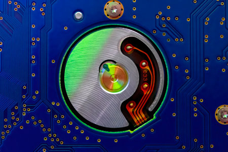 Hard drive internal mechanism hardware selective focus, in green blue light, Macro photographyの写真素材