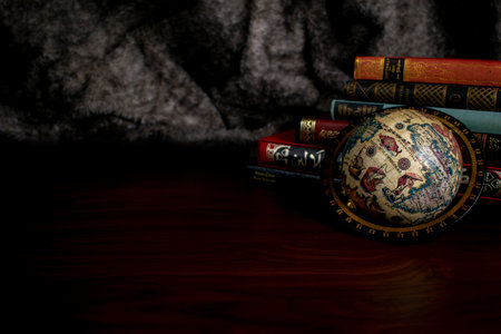 Antique books and globe map on tableの写真素材