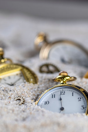 Pocket watches, group of old gold pocket watches on sand, macro photography.