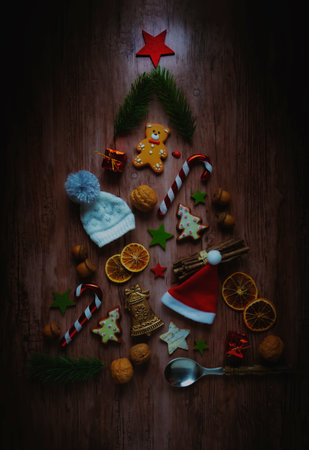 Christmas tree shaped of different ornaments. on wood background.の写真素材