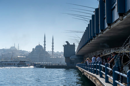 Fisherman fishing at the top of Galata Bridge Galata KÃ¶prÃ¼sÃ¼ and And below it are Restaurants that serve fish meals.のeditorial素材