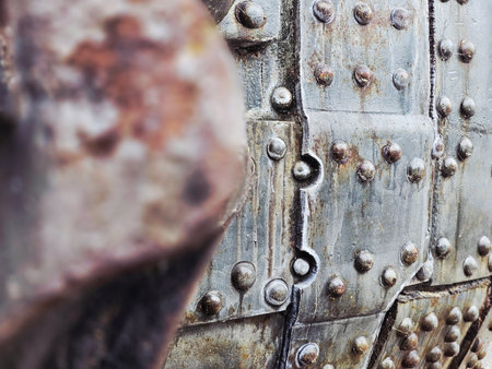 Old rusty metal door with rivets and rivets, closeup of photoの写真素材