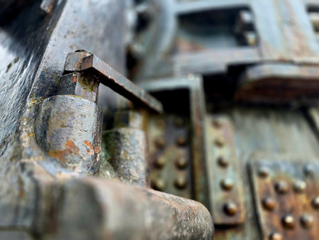 Large size bolts and nuts in iron and steel factories, old vintage rusty metal doorの写真素材