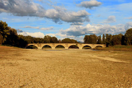 Buriano roman bridge (over a dry Arno), known because painted in the landscape behind Mona Lisa's paintingの写真素材