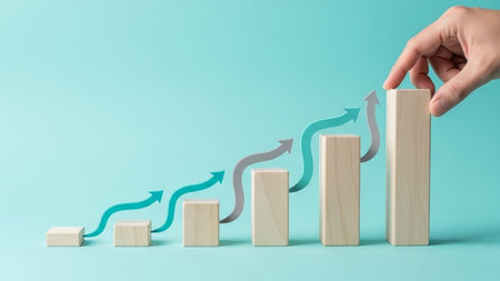 Concept of growth, increase, progress and progress in business. Businessman hand building a graph from wooden blocks.の素材