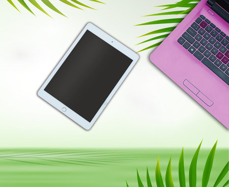 Laptop, tablet and mobile phone on green background with palm leaves.の写真素材