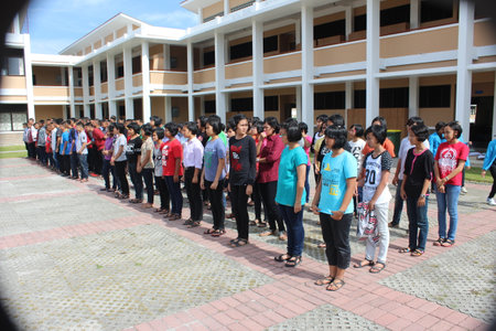 Unidentified students are walking in front of the school.の写真素材