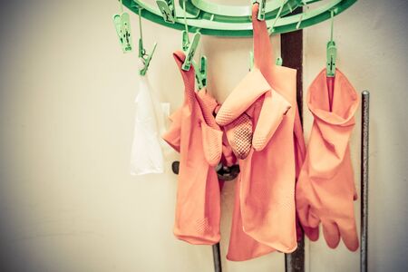 rubber gloves hanging on ropeの写真素材