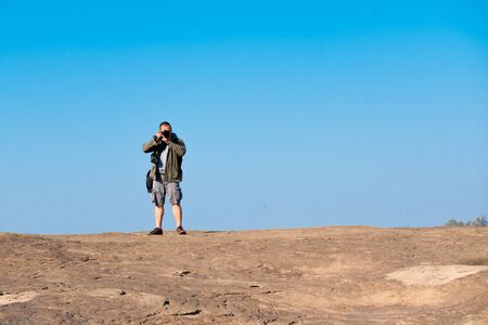 Nature photographer taking photos in the mountainsの写真素材