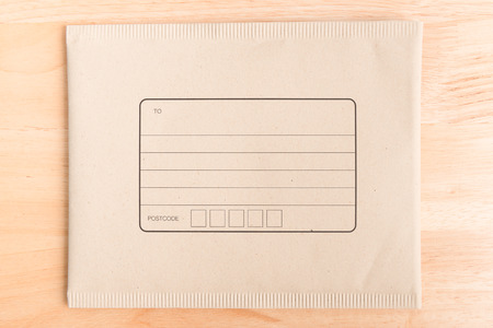 padded mailing envelopes on wood background