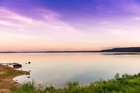 landscape with wide deep blue lake , forest and blue skyの写真素材