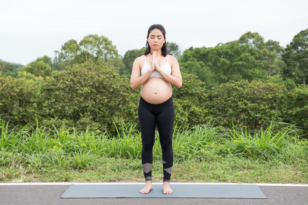 Pregnant woman doing exercise in relaxation on yoga pose. The concept of health and sportの写真素材
