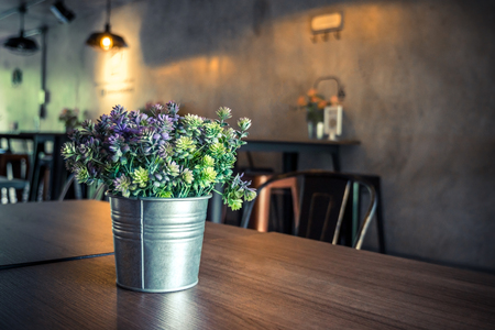 Green plant plastic in small pot on tableの写真素材