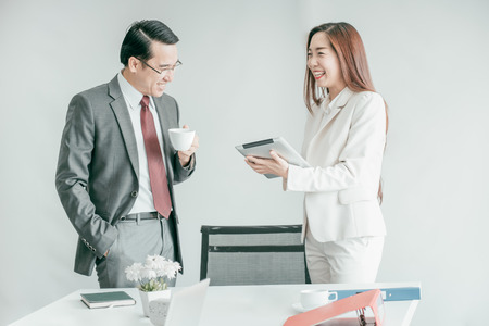 Business people having fun and talking at workplace officeの写真素材