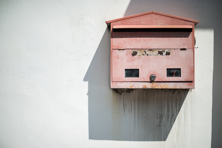 red mailbox on old wall backgroundの写真素材