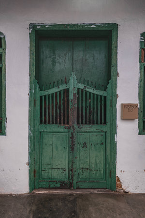 Green door in old stone houseの写真素材