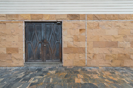 wood door in old stone houseの写真素材