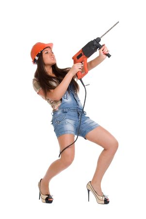 Young woman in orange helmet holding hammer drillの写真素材