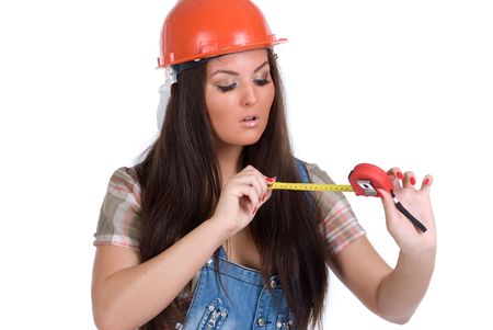  Young woman in orange helmet holding tape measureの写真素材