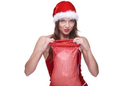 Closeup portrait of beautiful emotional girl with green eyes weared in santa clause dress and gifts bagの写真素材