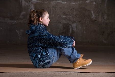 Hip hop girl dancing in modern style over urban grey brick wallの写真素材