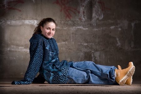 Hip hop girl dancing in modern style over urban grey brick wallの写真素材