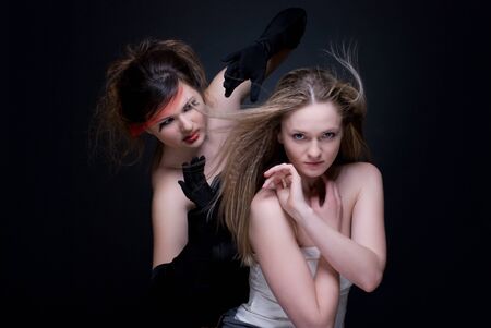 Closeup portrait of two girls: black & white or good & evilの写真素材