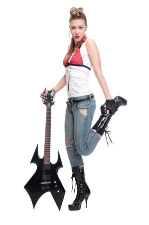 Portrait of beautiful young rock woman with black electric guitar. Isolated on whiteの写真素材
