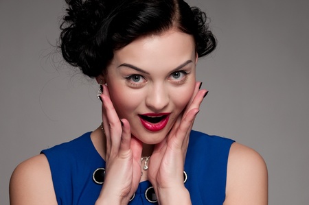 Closeup beautiful emotional glamour woman with red lips. Blue dress, black nails and beads. Vogue