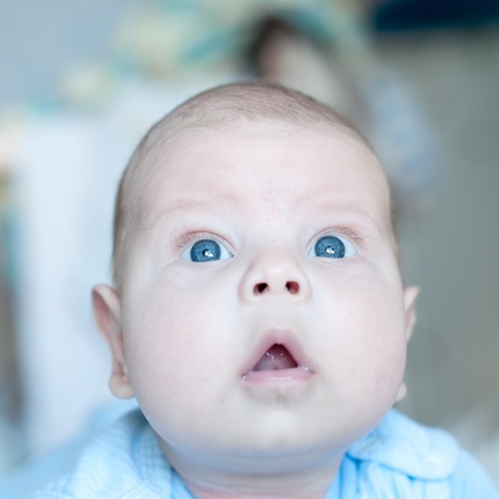 A cute little baby The baby could be a boy or girl and has blue eyes. Sure