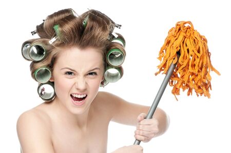 Angry crazy housewife in hair rollers is holding swabの写真素材