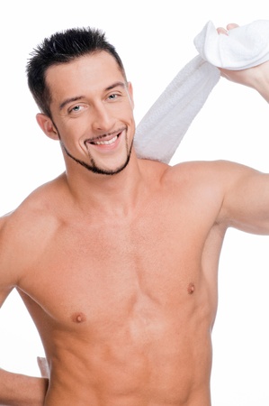 Close up portrait of young handsome man face with perfect skin and towel. Isolated on whiteの写真素材