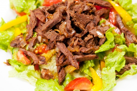 Macro shot of spice Mexican salad with meat on white plate の写真素材