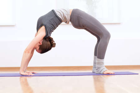 Beautiful sport woman doing stretching fitness exercise at sport gym. Yoga 