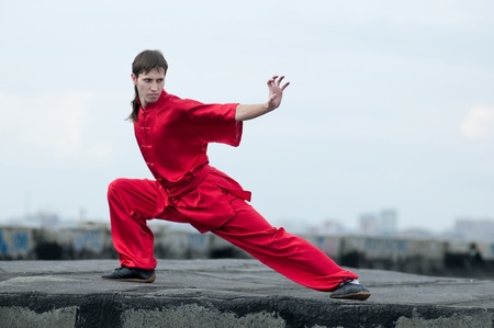 Shaolin warriors wushoo man in red practice martial art outdoor. Kung fuの写真素材