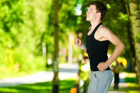 Young man jogging in park. Health and fitness.