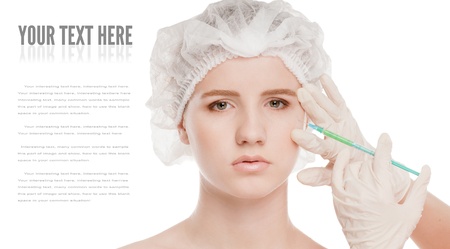 Cosmetic botox injection in the female face. Eye and eyebrow zone. Isolated on whiteの写真素材