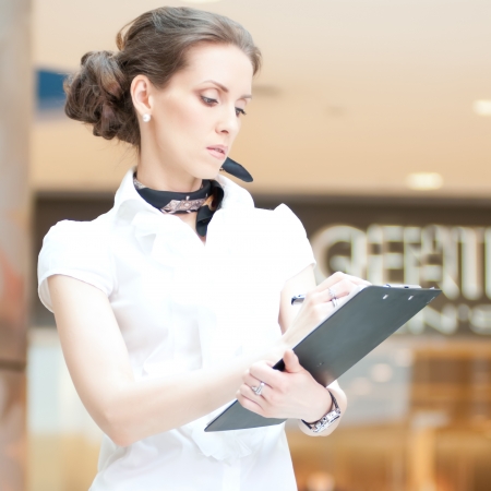Business woman working with documents: writing with penの写真素材