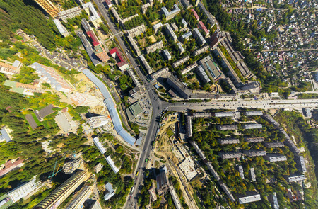 Aerial city view with crossroads and roads, houses, buildings, parks and parking lots, bridges. Copter shot. Panoramic image. Aerial city view with crossroads and roads, houses, buildings, parks and parking lots, bridges. Copter shot. Panoramic image.