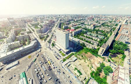 Aerial city view with crossroads and roads, houses, buildings, parks and parking lots, bridges. Urban landscape. Copter shot. Panoramic image.の写真素材