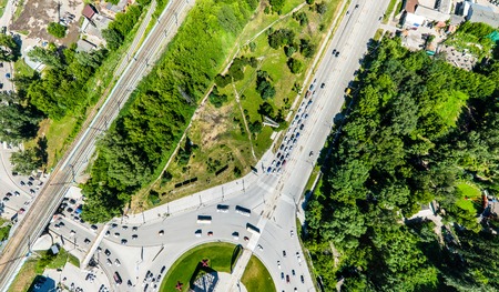 Aerial city view with roads, houses and buildings.