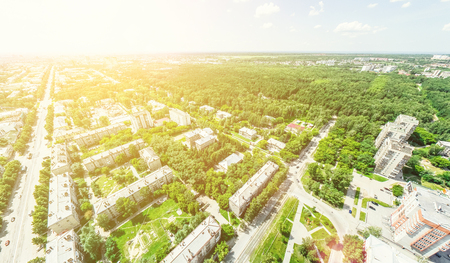 Aerial city view with crossroads and roads, houses, buildings, parks and parking lots, bridges. Helicopter drone shot. Wide Panoramic image.の写真素材