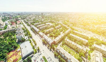 Aerial city view with crossroads and roads, houses, buildings, parks and parking lots, bridges....